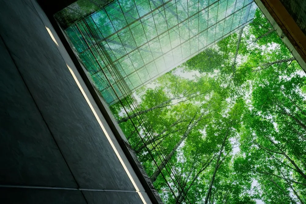 Glass-roofed commercial building surrounded by trees